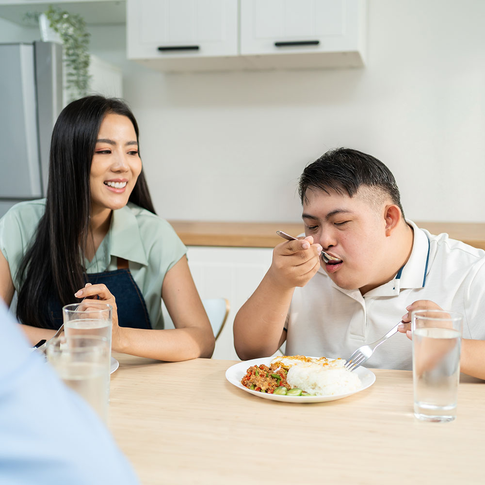 Patient with disabilities eating breakfast